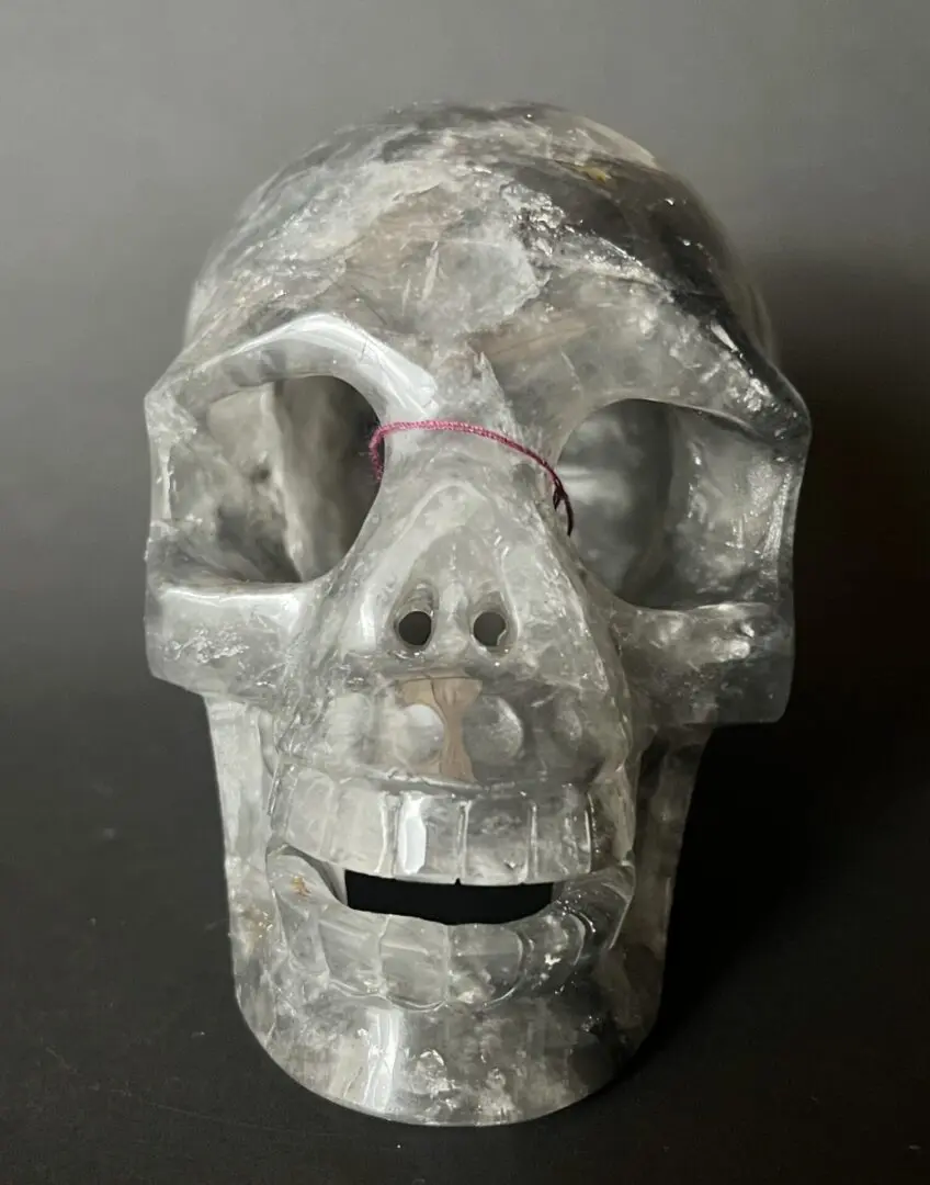 A skull made of plastic sitting on top of a table.