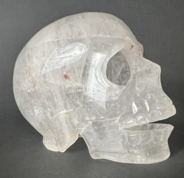 A clear skull with a hole in the middle of it.