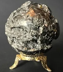 A large rock with gold trim on top of it.