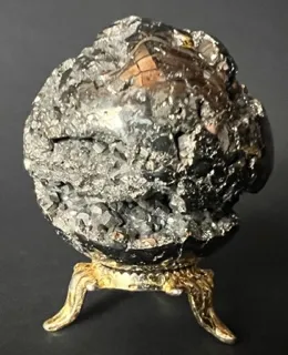 A large rock with gold trim on top of it.