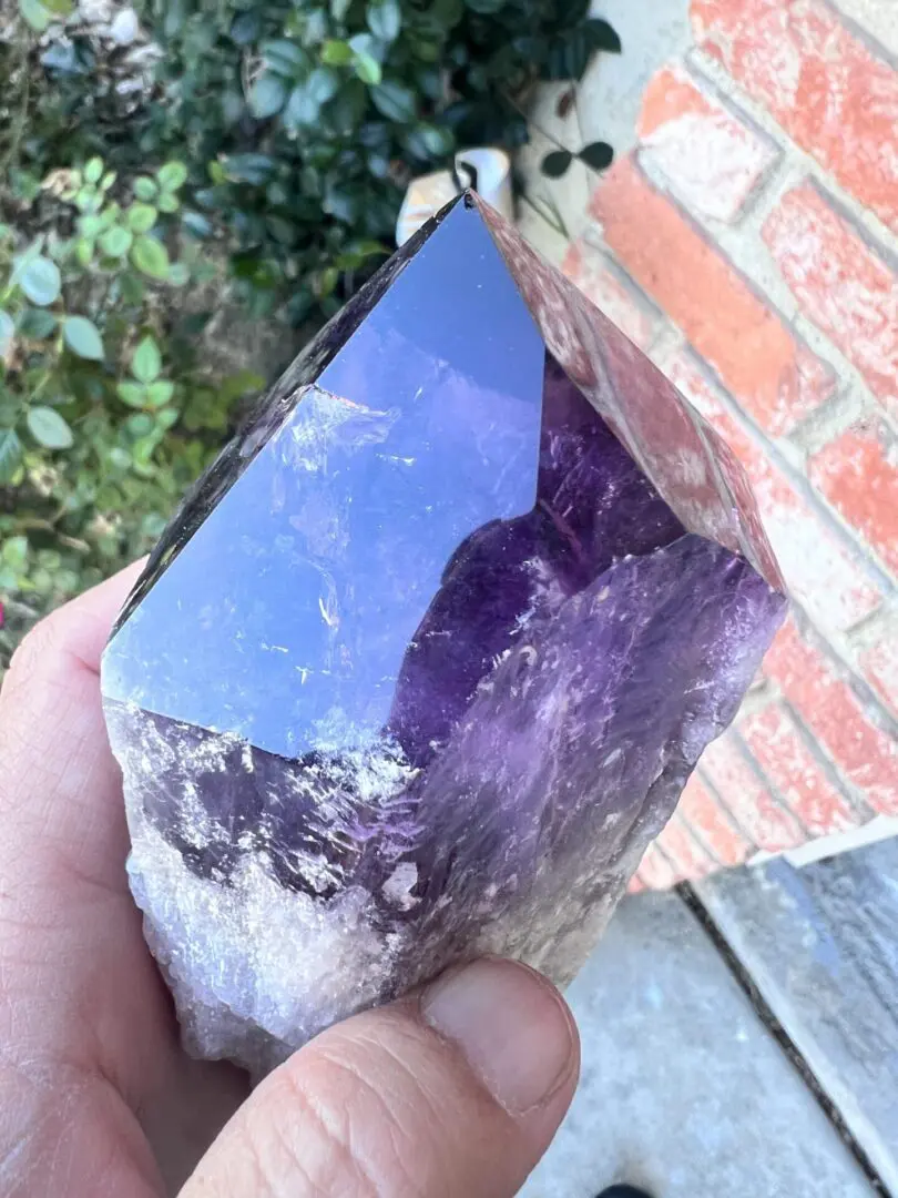 A Large Amethyst Dragon’s Tooth Scepter in a person's hand from Bahia, Brazil 584 grams.