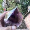 A person holding up a Large Amethyst Dragon's Tooth Scepter From Bahia, Brazil 902 grams.