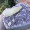 A person is holding a piece of Uruguayan Amethyst Cut Base with Secondary Calcite 1,212 grams crystal.