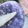 An Uruguayan Amethyst Cut Base with Secondary Calcite 1,212 grams with an amethyst point and secondary calcite on it.