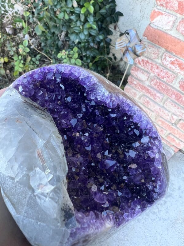 A Uruguayan Amethyst Cut Base with Secondary Calcite 932 grams with purple crystals and secondary Calcite on it.