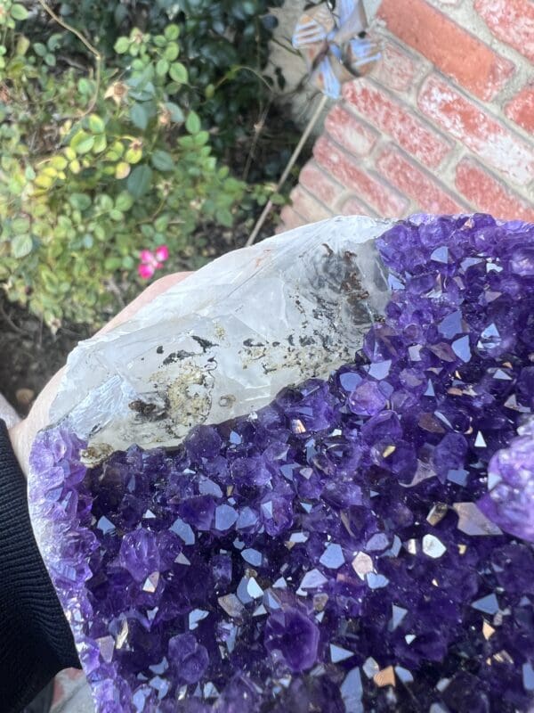 Uruguayan Amethyst Cut Base with Secondary Calcite 932 grams in a plastic bag.